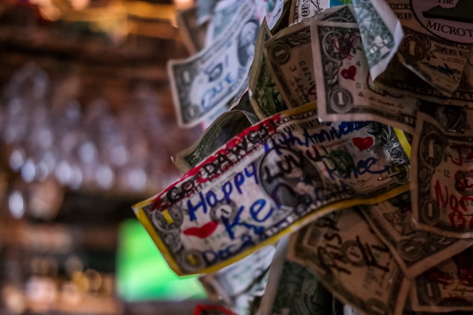 best things to do in charleston: the dollar bills on the wall at the Griffon